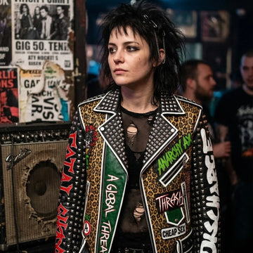 Women wearing a studded punk-style leather biker jacket with leopard print panels, graphic patches and an asymmetrical zipper.